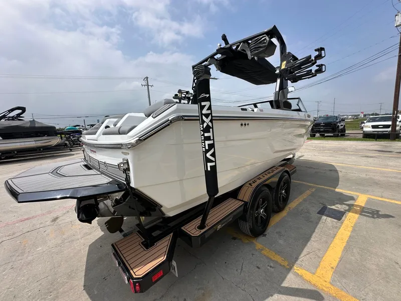 Slide: The Image of 2026 Nautique Super Air Nautique GS22 on trailer, side view. - 6