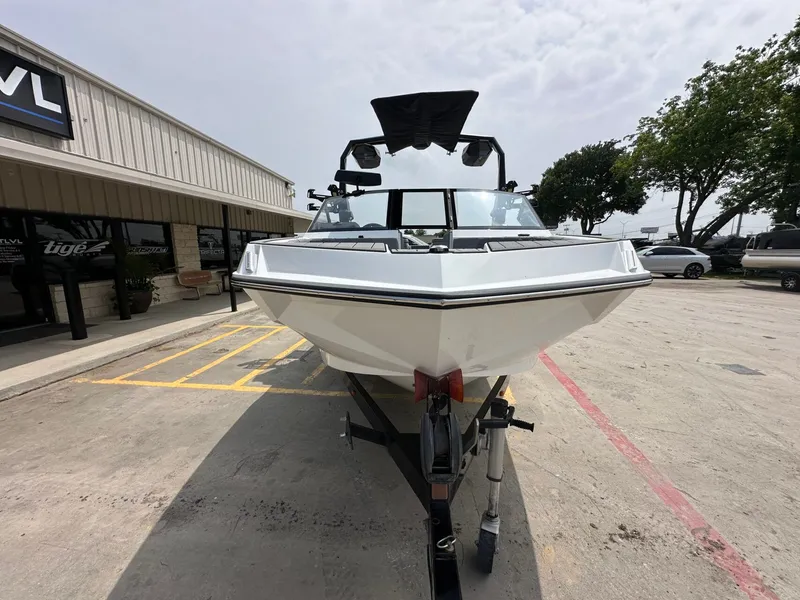 Slide: The Image of 2026 Nautique Super Air Nautique GS22 on a trailer outside a building. - 9