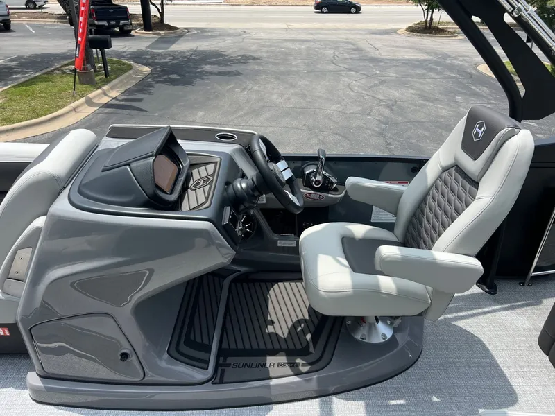 Slide: The Image of Interior of Harris Sunliner 250 boat, 2026 model, featuring luxurious helm seat. - 19