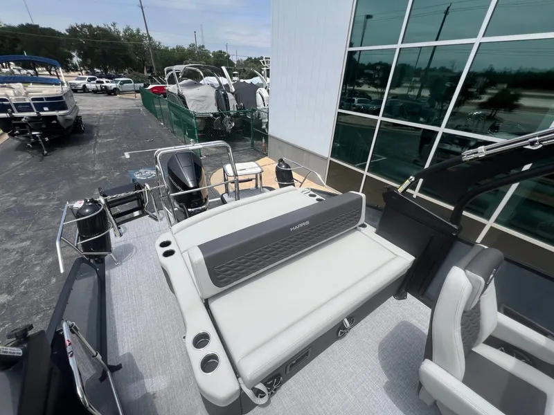 Slide: The Image of Harris Sunliner 250 boat 2026 displayed in a parking lot. - 23