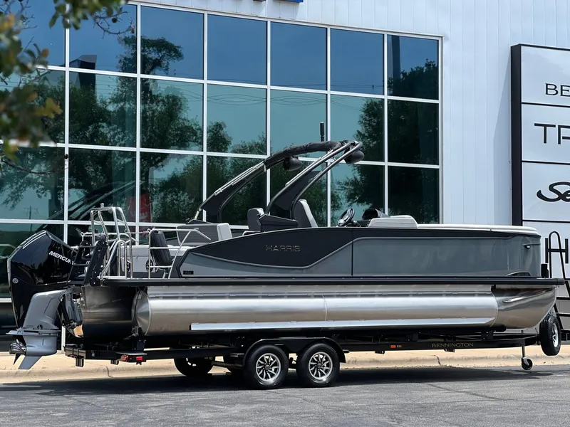 Slide: The Image of 2026 Harris Sunliner 250 pontoon boat in front of a modern building. - 3