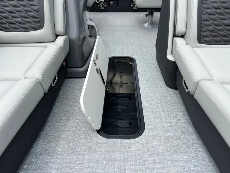 Slide: The Image of Interior of Harris Sunliner 250 boat with open storage compartment. - 34
