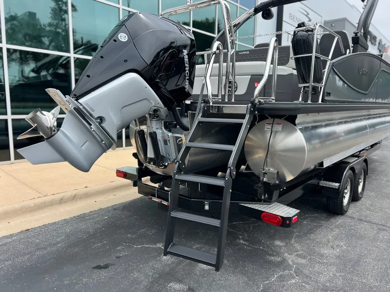 Slide: The Image of 2026 Harris Sunliner 250 pontoon boat with Mercury outboard motor. - 4