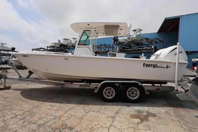 The Image of 2023 Everglades 273 Center Console boat on trailer, parked outdoors. - 0