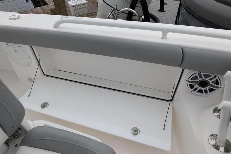 Slide: The Image of 2023 Everglades 273 Center Console boat interior with storage compartment and speaker. - 11