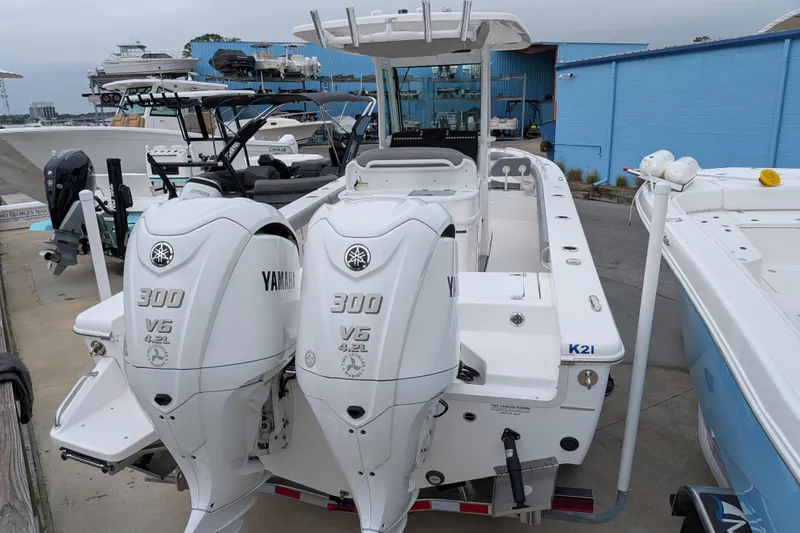 Slide: The Image of 2023 Everglades 273 Center Console boat with twin Yamaha 300 V6 engines docked. - 12