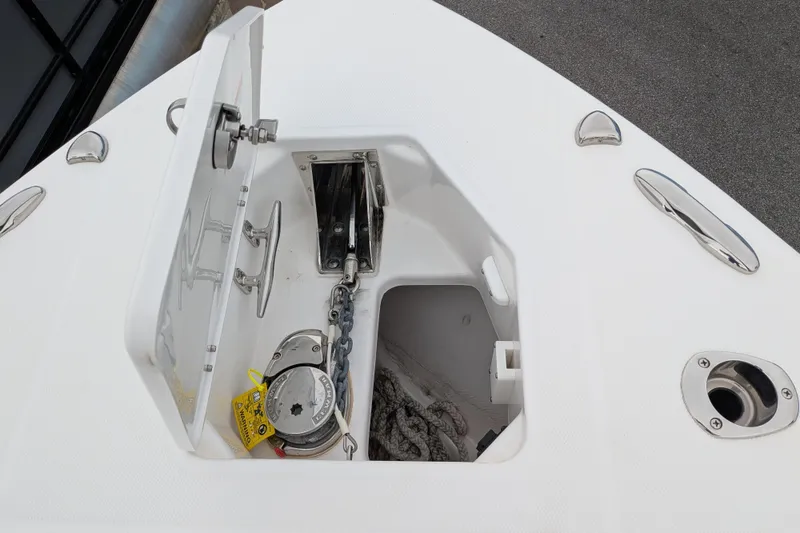 Slide: The Image of Anchor compartment of 2023 Everglades 273 Center Console boat, featuring chain and rope storage. - 6