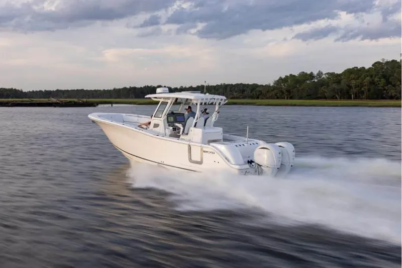 The Image of 2026 Sea Fox 328 Commander cruising on a serene waterway under a cloudy sky. - 1