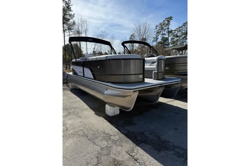 The Image of 2025 Crest CLASSIC 220 SLC pontoon boat parked outdoors on a sunny day. - 1