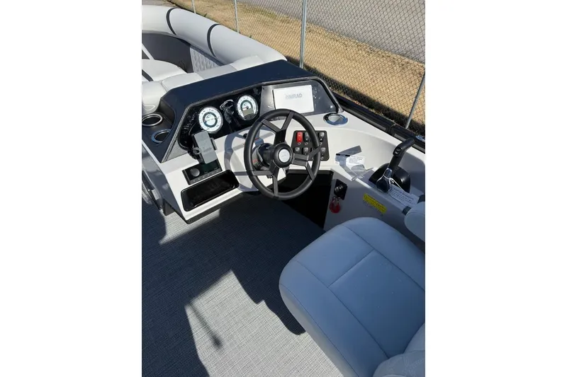 Slide: The Image of 2025 Crest CLASSIC 220 SLC boat dashboard with steering wheel and controls. - 9