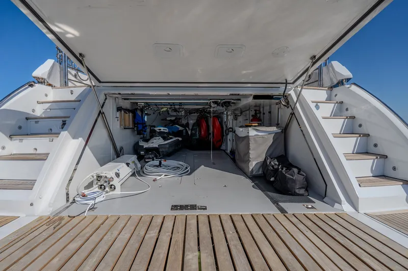 Slide: The Image of Open storage area on a 2004 Sunseeker 105 Yacht, featuring equipment and stairs. - 83