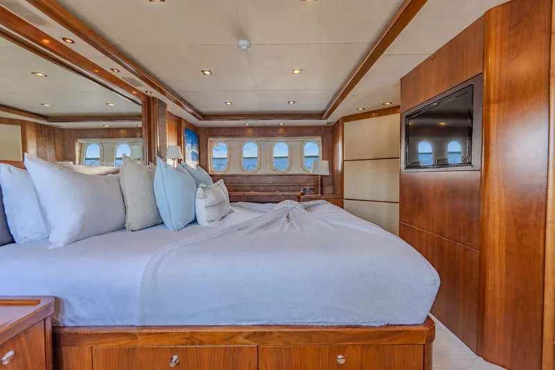 Slide: The Image of Luxurious bedroom interior of 2004 Sunseeker 105 Yacht with elegant wood paneling. - 64