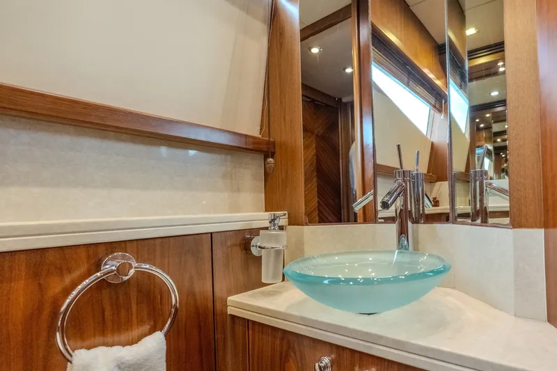 Slide: The Image of Luxurious bathroom on 2004 Sunseeker 105 Yacht with glass sink and wooden accents. - 52