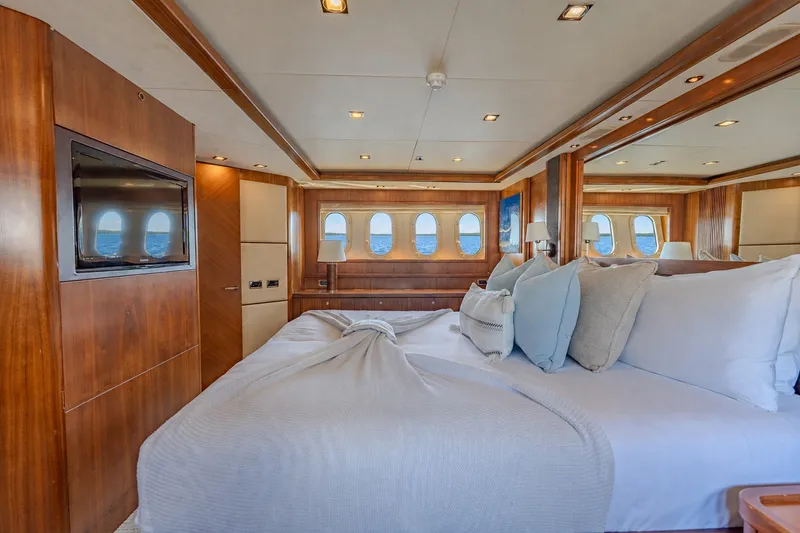 Slide: The Image of Luxurious bedroom interior of 2004 Sunseeker 105 Yacht with elegant wood paneling and ocean view. - 65