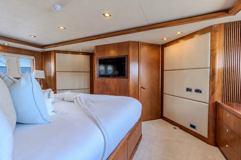 Slide: The Image of Luxurious bedroom interior of 2004 Sunseeker 105 Yacht with wood paneling and modern amenities. - 66