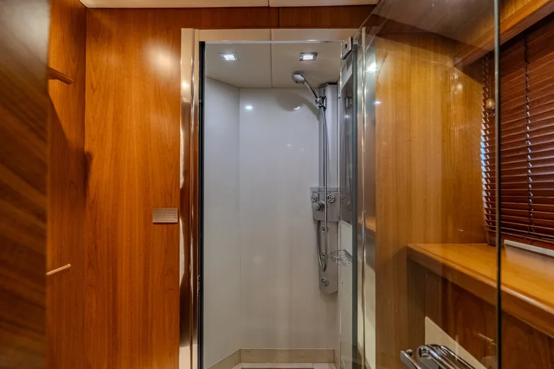 Slide: The Image of Luxurious shower area in a 2004 Sunseeker 105 Yacht, featuring elegant wood paneling. - 80