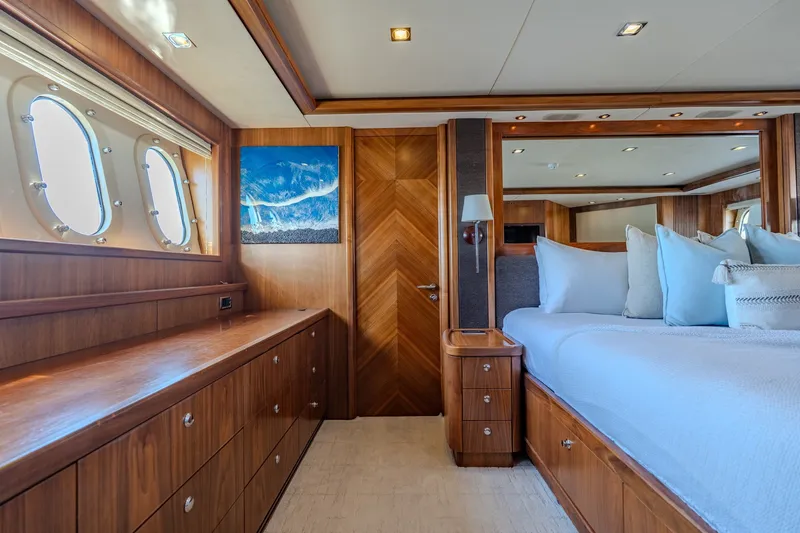 Slide: The Image of Luxurious 2004 Sunseeker 105 Yacht bedroom with elegant wood finishes and ocean view. - 69