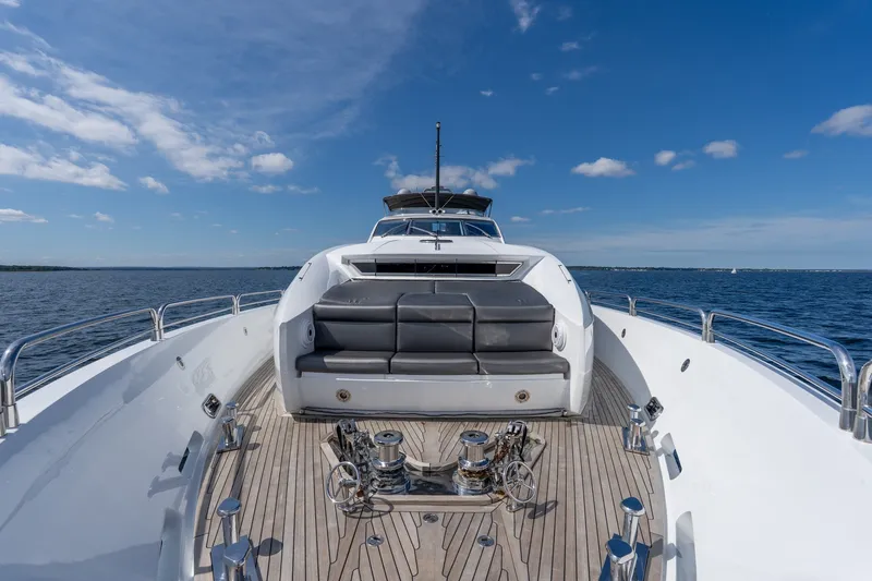 Slide: The Image of 2004 Sunseeker 105 Yacht deck with seating, cruising on open water under blue skies. - 38