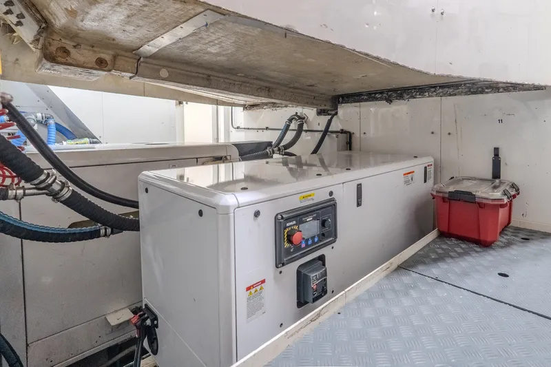 Slide: The Image of Engine room of a 2004 Sunseeker 105 Yacht with machinery and storage container. - 85