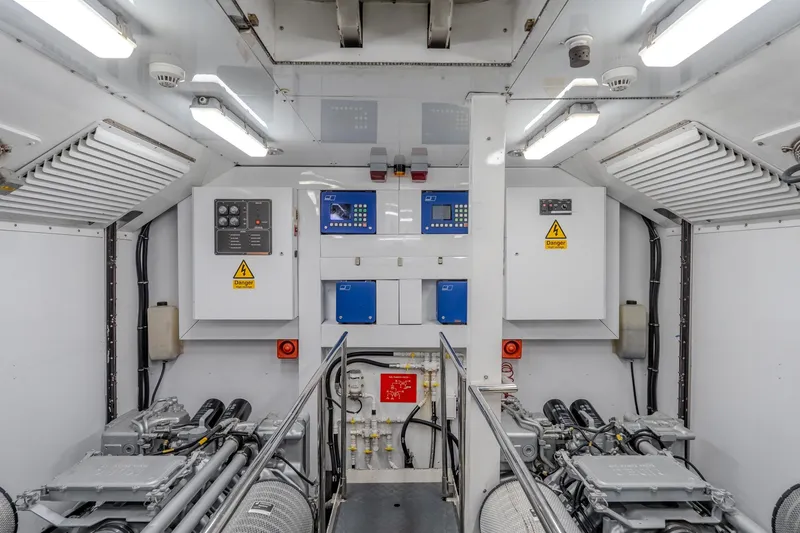 Slide: The Image of Engine room of a 2004 Sunseeker 105 Yacht, featuring control panels and machinery. - 87