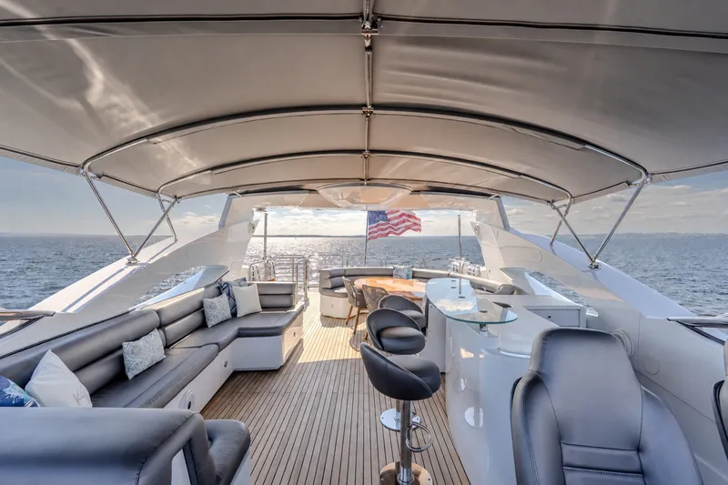 Slide: The Image of Luxurious 2004 Sunseeker 105 Yacht deck with seating, bar, and ocean view. - 18