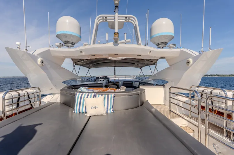 Slide: The Image of Luxurious 2004 Sunseeker 105 Yacht deck with seating, ocean view, and radar equipment. - 15