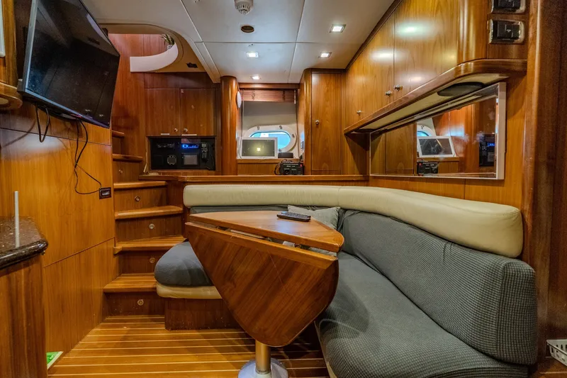 Slide: The Image of Luxurious interior of a 2004 Sunseeker 105 Yacht with wood paneling and cozy seating area. - 81