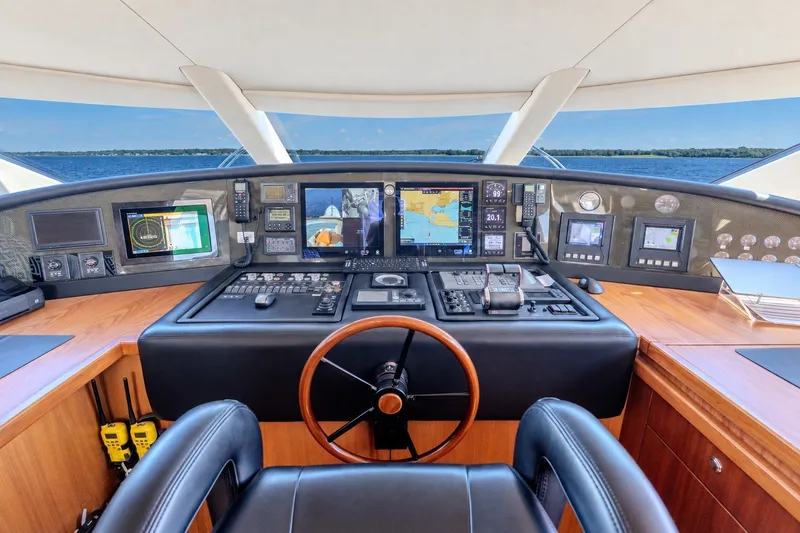 Slide: The Image of Cockpit of 2004 Sunseeker 105 Yacht with navigation equipment and steering wheel. - 28