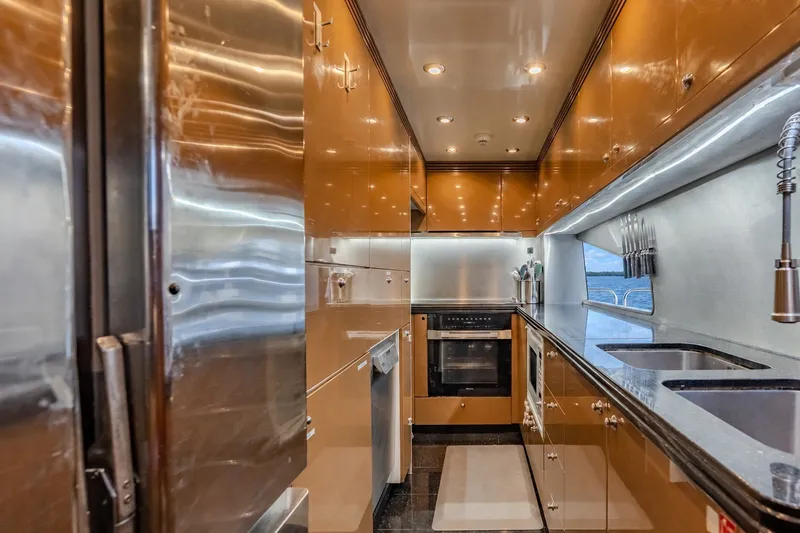 Slide: The Image of Luxurious kitchen interior of a 2004 Sunseeker 105 Yacht, featuring modern appliances and sleek cabinetry. - 53