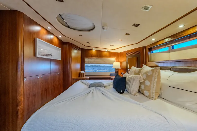 Slide: The Image of Luxurious bedroom interior of a 2004 Sunseeker 105 Yacht with elegant wood paneling. - 59