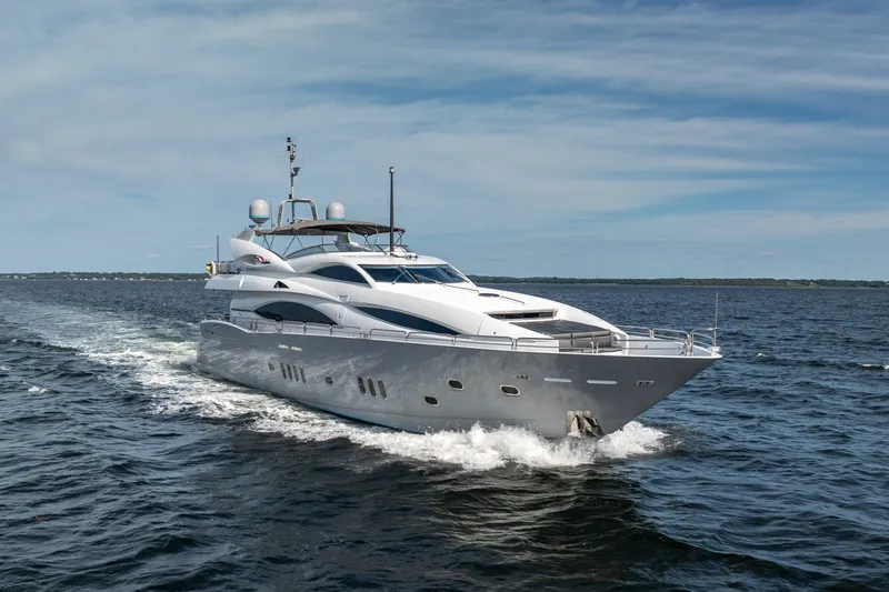 Slide: The Image of Luxurious 2004 Sunseeker 105 Yacht cruising on open water under a clear sky. - 14