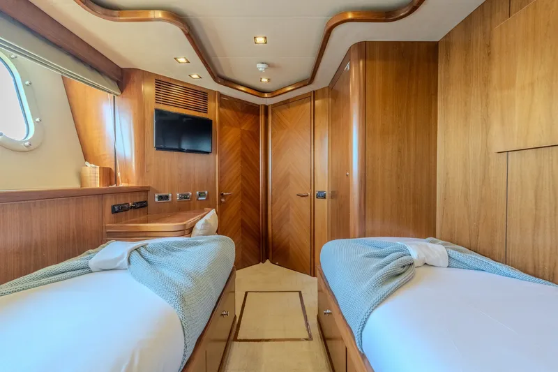 Slide: The Image of Luxurious twin cabin interior on 2004 Sunseeker 105 Yacht with wood paneling. - 74