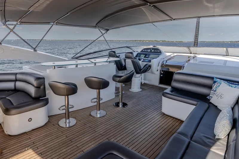 Slide: The Image of Luxurious 2004 Sunseeker 105 Yacht deck with sleek seating and modern helm. - 19
