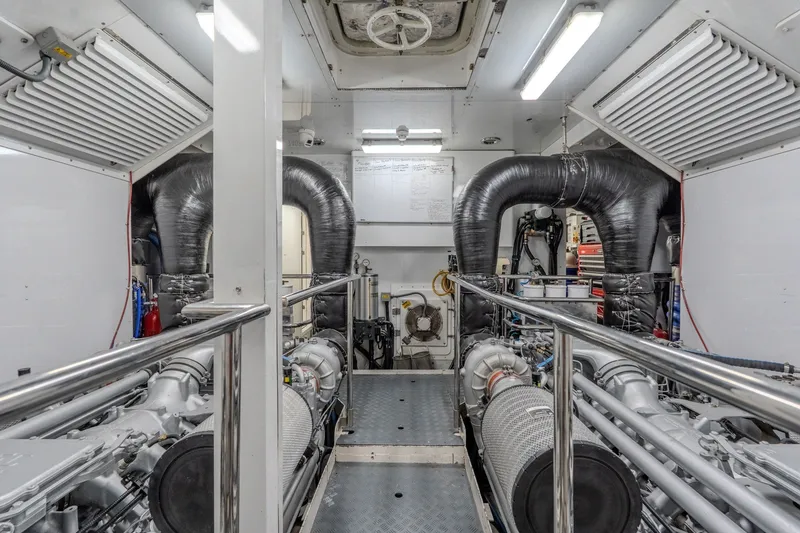 Slide: The Image of Engine room of a 2004 Sunseeker 105 Yacht, featuring dual engines and ventilation systems. - 86
