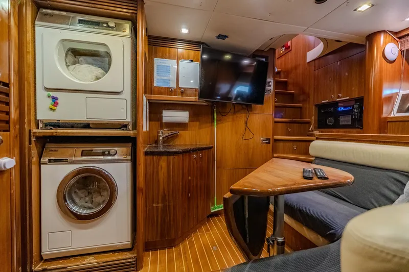 Slide: The Image of Luxurious 2004 Sunseeker 105 Yacht interior with laundry, TV, and seating area. - 82