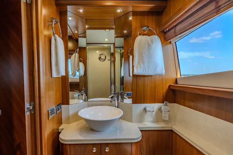Slide: The Image of Luxurious bathroom interior on a 2004 Sunseeker 105 Yacht, featuring elegant wood finishes. - 61