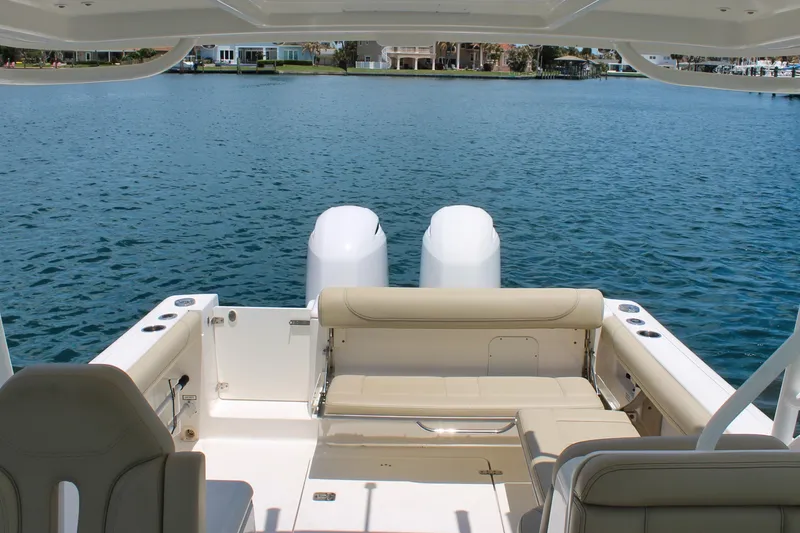 Slide: The Image of 2018 Pursuit DC 265 Dual Console boat with spacious seating on calm water. - 10