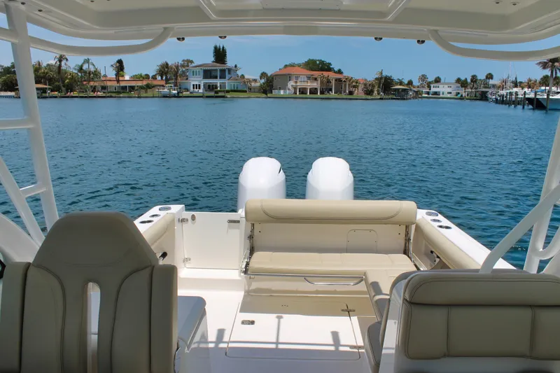 Slide: The Image of 2018 Pursuit DC 265 Dual Console boat interior with waterfront view. - 11