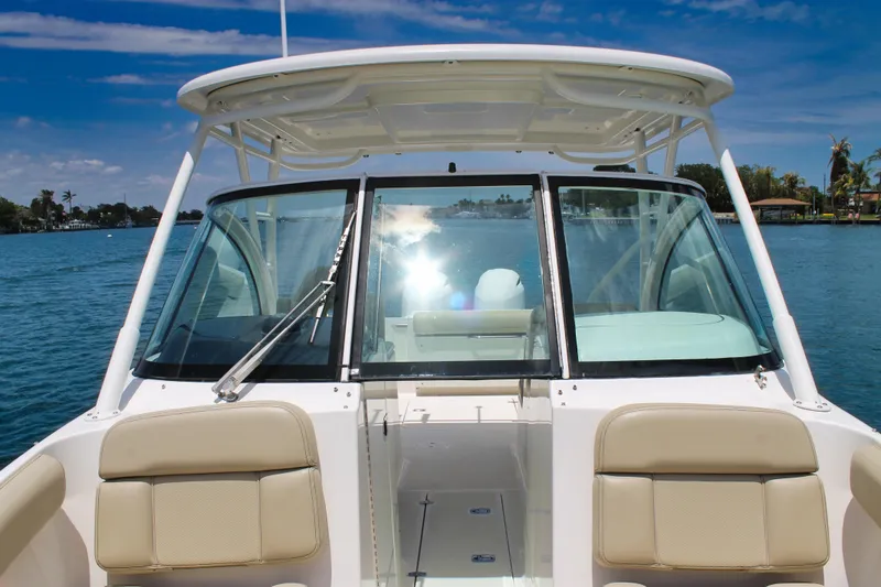 Slide: The Image of 2018 Pursuit DC 265 Dual Console boat on calm water, sunny day. - 22