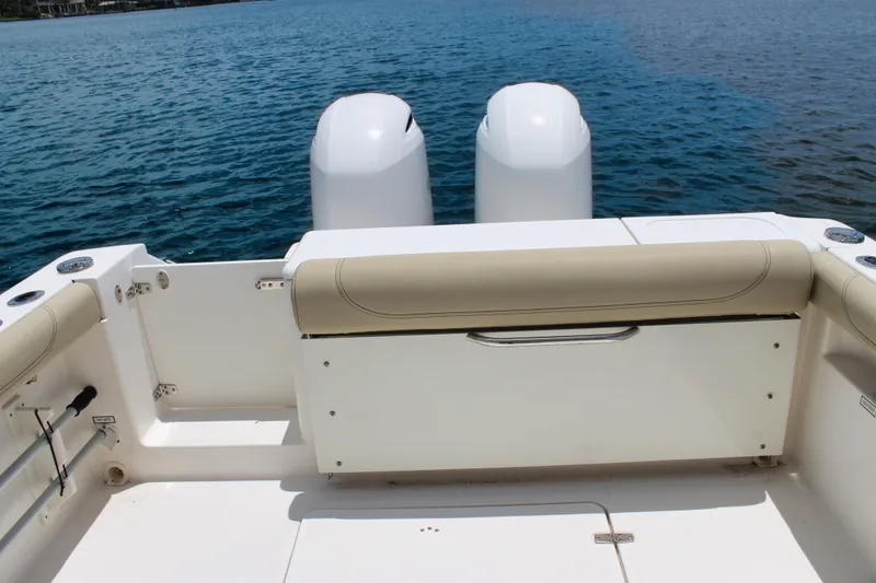 Slide: The Image of 2018 Pursuit DC 265 Dual Console boat with twin engines on calm water. - 28