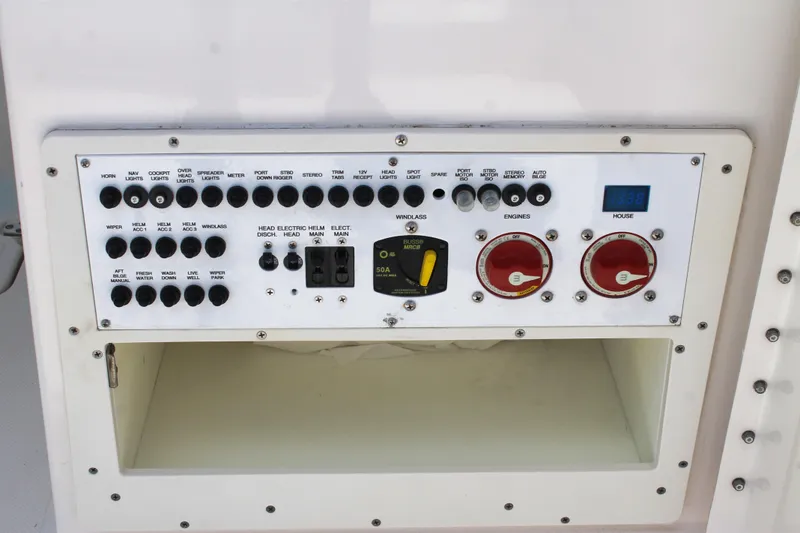 Slide: The Image of Control panel of a 2018 Pursuit DC 265 Dual Console boat with various switches and dials. - 29