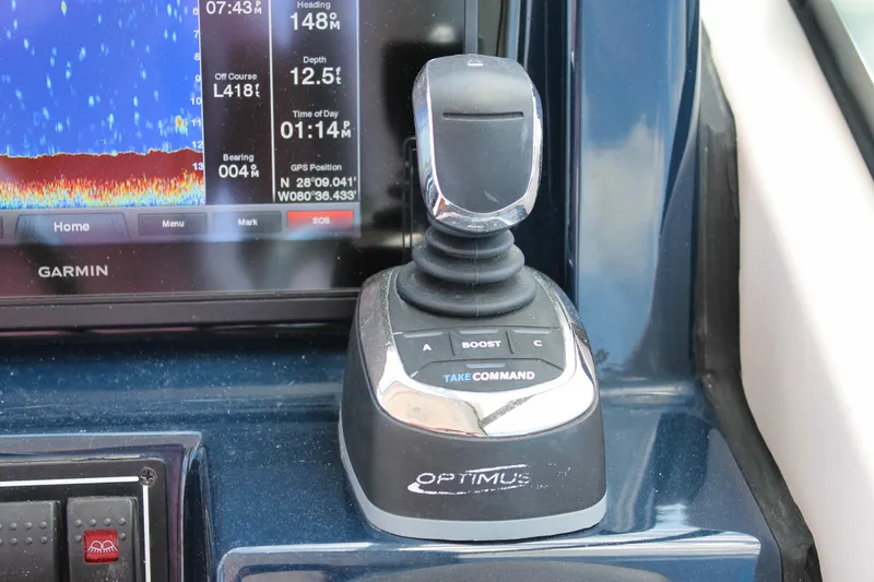 Slide: The Image of Joystick control and Garmin display on 2018 Pursuit DC 265 Dual Console boat. - 32
