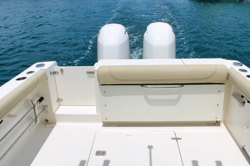 Slide: The Image of 2018 Pursuit DC 265 Dual Console boat with twin engines on open water. - 34