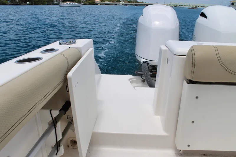 Slide: The Image of 2018 Pursuit DC 265 Dual Console boat with twin engines on open water. - 38