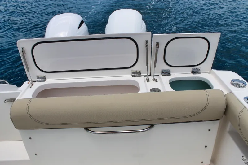 Slide: The Image of 2018 Pursuit DC 265 Dual Console boat with open storage compartments on deck. - 39