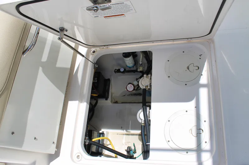 Slide: The Image of Open hatch of 2018 Pursuit DC 265 Dual Console boat showing internal components. - 7
