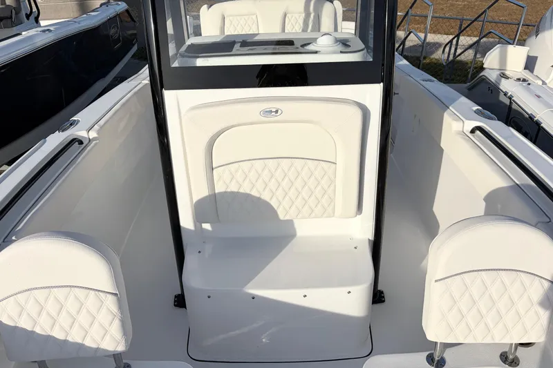 Slide: The Image of 2026 Sea Hunt Ultra 255 SE boat interior with white seating and console. - 11