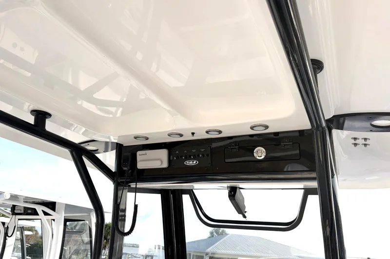 Slide: The Image of 2026 Sea Hunt Ultra 255 SE boat console with electronic controls and storage. - 12