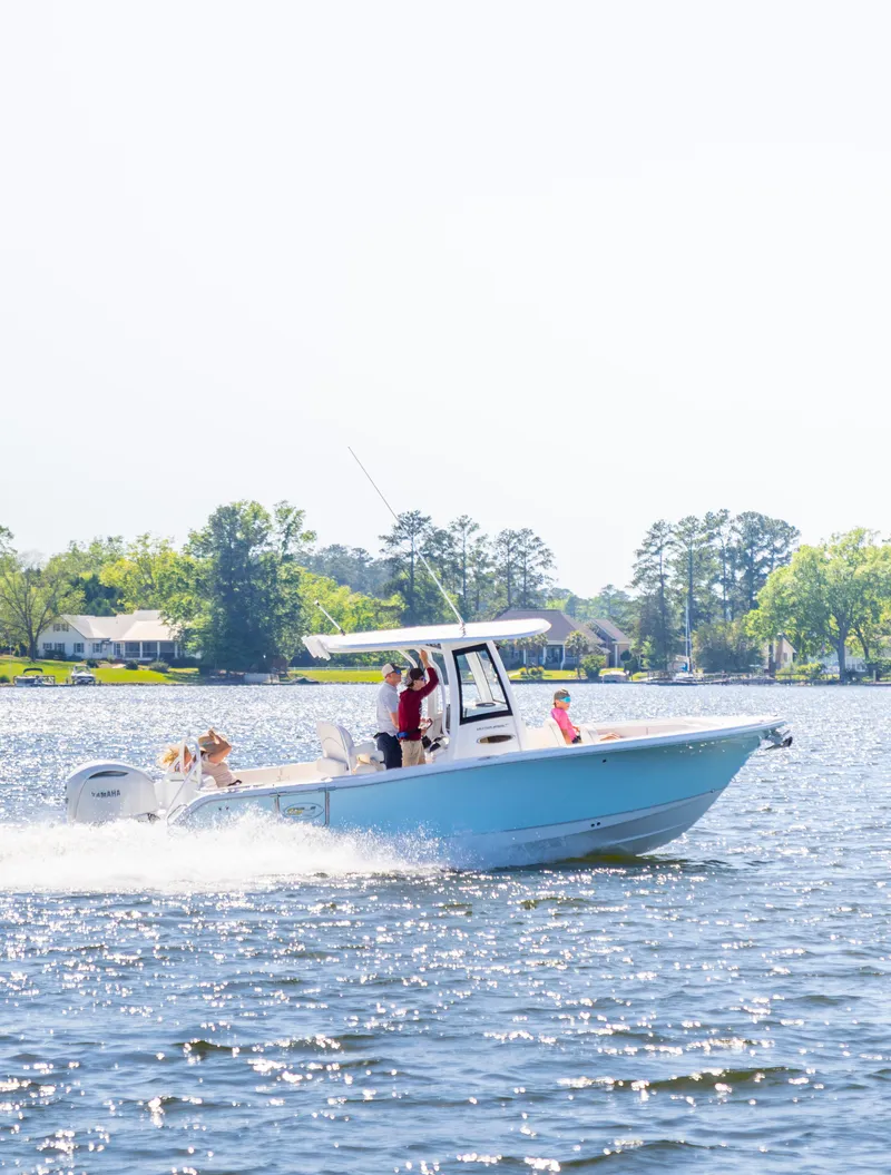 Slide: The Image of 2026 Sea Hunt Ultra 255 SE boat cruising on a sunny lake. - 17