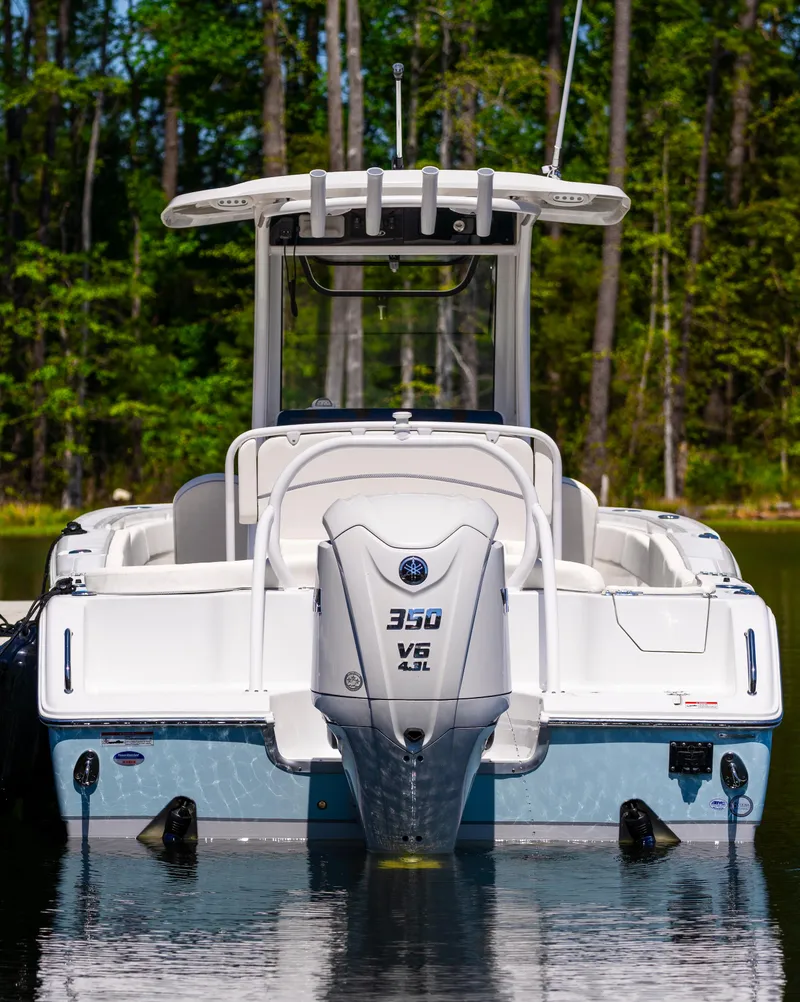 Slide: The Image of 2026 Sea Hunt Ultra 255 SE boat with 350 V8 engine on a calm lake. - 20